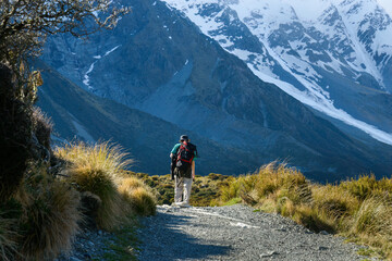 Fototapeta premium Man hiking Hooker Valley track. Mt Cook National Park. New Zealand.