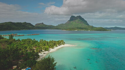 Stunning aerial drone footage capturing the beauty of Bora Bora, with mount Otemanu rising...