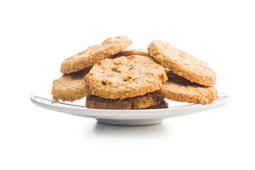 Sweet oatmeal cookies on plate isolated on white background.