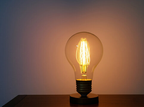 A vintage Edison light bulb with a glowing filament,