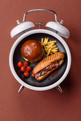 Hot dog, a sandwich with sausage, mustard, mayonnaise and ketchup . Concept of time to eat fast food