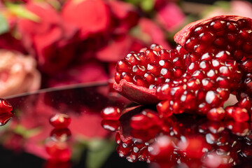 peeled ripe red pomegranate with juicy grains, side view
