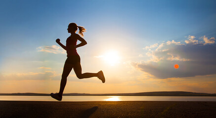 Silhouette of a young girl running along the road along the sea coast