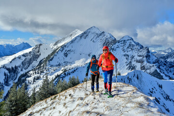 Man and woman snowshoeing in the Bavarian Alps at Sch�nfeldjoch in Germany