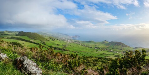 Panoramic Coastal View of Sao Jorge Island Countryside from Miradouro do Pico da Velha, Azores. Lush green hills, charming villages, vast ocean, scenic landscape