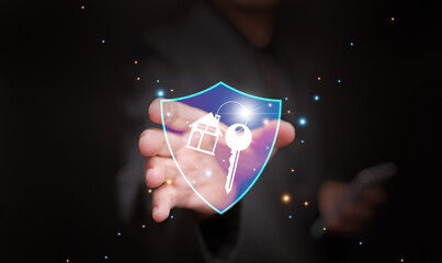 Real estate, house, or property insurance concept. A man holding house with key icon behind a shield, symbolizing coverage that protects against various risks