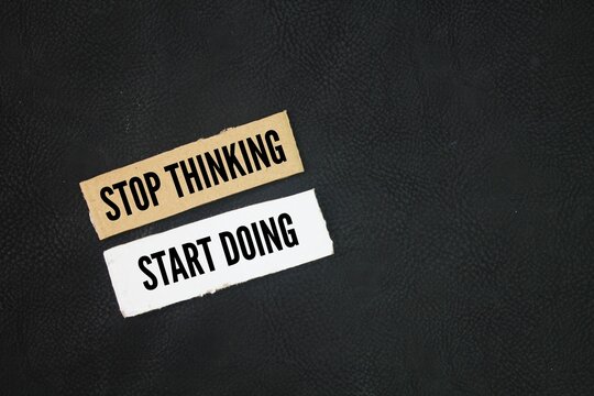 Naklejki Paper with inspirational and motivational things or quotes stop thinking, start doing concept for beginners or just starting out.