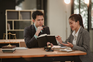 Male and female lawyers discuss legal matters in an office.