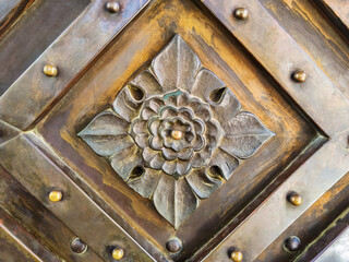 Ornate architectural relief floral-style iron detail. Wrought-iron floral pattern on old metal...