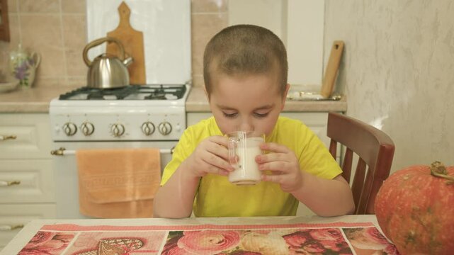 Son Boy In Home Drinks Milk From A Glass Cup. Portrait Pretty Little Boy Drinks Milk. Balanced Diet. Gimbal Stabilize.