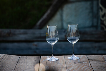empty wine glass seen through bottles