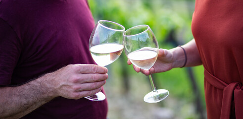 happy couple tasting wine in a vineyard