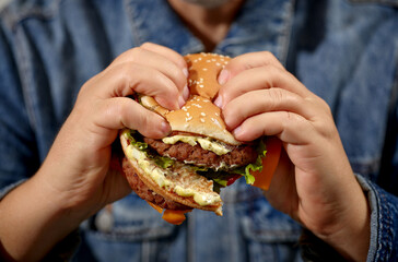broken burger in human hands