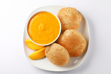 Aam ras served with puri and slice of mango. Delicious Indian Snack 