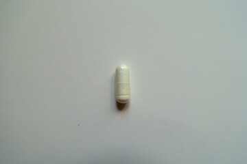 1 white capsule of acetyl cysteine dietary supplement from above