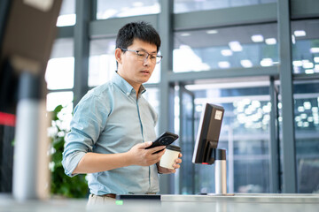 asian businessman Pass through the automatic turnstile using facial recognition