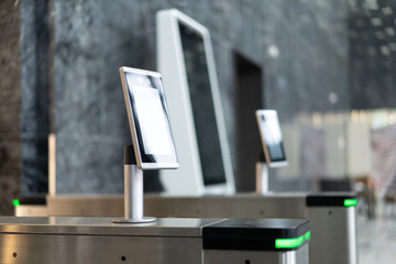 Facial recognition automatic turnstile in lobby of modern office