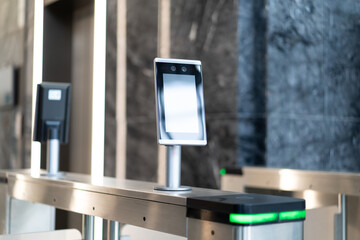 Facial recognition automatic turnstile in lobby of modern office
