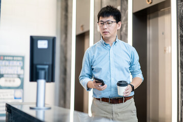 asian businessman Pass through the automatic turnstile using facial recognition