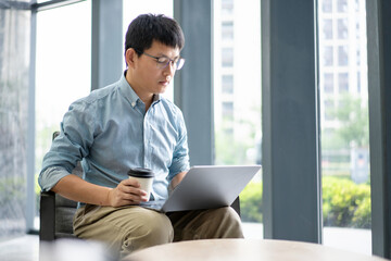 Fototapeta premium asian businessman working on laptop in office