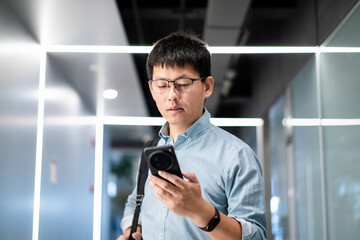 asian businessman using smart phone in office