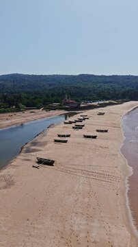 Aerial portrait around traditional Dhoni fishing boats at a beach in sunny India