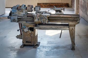 Vintage lathe dominating workshop space, showcasing industrial heritage
