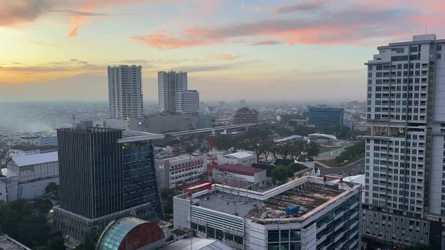 Medan capital city Indonesia North Sumatra province city skyline buildings sunrise