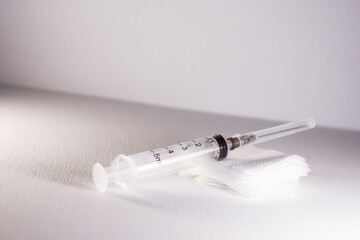 Close-Up of Syringe on White Gauze Pad
