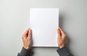 Woman hands hold blank white paper on white background. Presentation advertising design. Empty sheet with copy space for message text. Corporate concept. Perfect for mockups business proposals.
