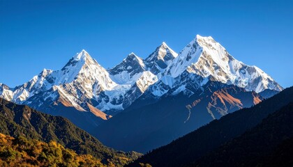 Elegant landscape photo of towering snow-capped mountains under a clear blue sky, majestic peaks