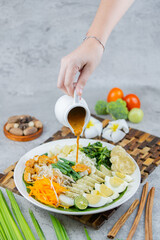 Traditional Indonesian salad made of boiled vegetables, tofu, eggs, and tempeh, served with rich peanut sauce. A flavorful and healthy plant-based dish.