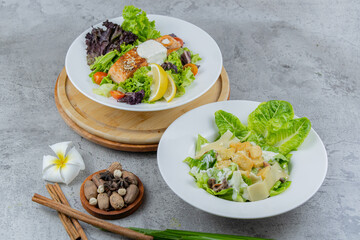 Healthy salmon salad with mixed greens, grilled salmon, cherry tomatoes, and lemon. A light and fresh dish perfect for healthy eating and food photography.