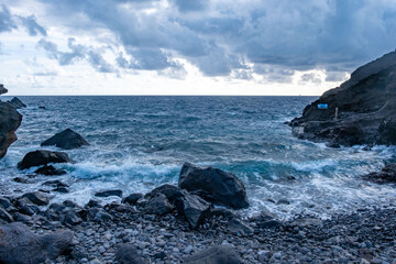 Dramatic volcanic cliffs rise above Atlantic ocean on Madeira island, natural landmark, geological...
