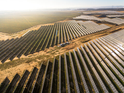 Rows of solar panels stretch across the Zaragoza plains&mdash;clean energy patterns emerging in the dry, arid landscape of Spain's renewable revolution.