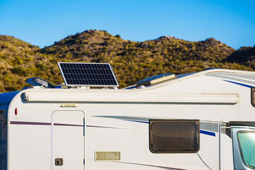 Caravan with tilt solar panels on roof.