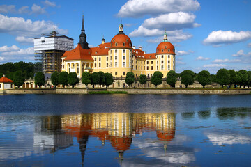 Moritzburg castle reflecting in the lake under blue sky
