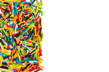 Sweet sugar colorful sprinkles pile, granules scattered isolated on white background