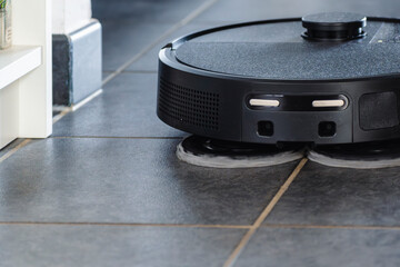 Robot vacuum cleaner with dust, real life photo, saves time and goes into hard-to-reach places