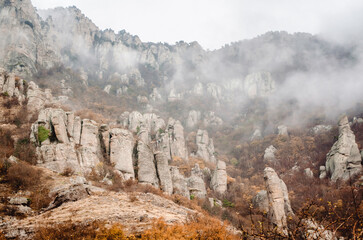 Striking rock formations rise through misty envelope in crimean mountains. Natural landscape...