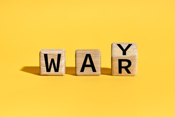Flipping wooden cube blocks with WAR to WAY text over yellow background