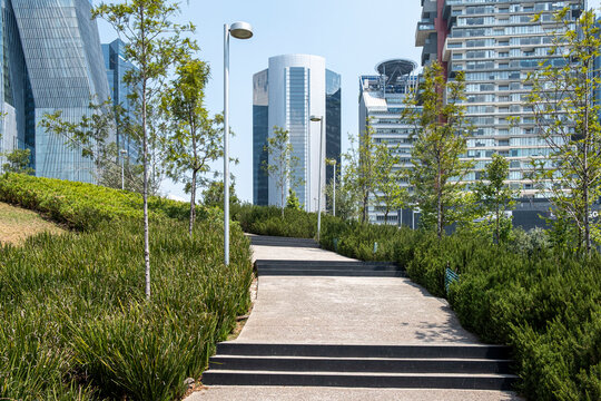 Green pathway and stairs in La Mexicana Park, Santa Fe, Mexico City, modern architecture and nature blend, ideal for lifestyle, city living, and architecture stock.
