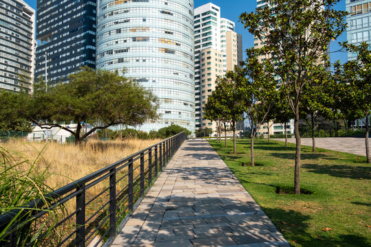 Modern architecture and bike paths in La Mexicana Park, Santa Fe, Mexico City, urban green space with high-rise buildings and nature, ideal for lifestyle and city stock.