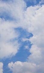 Beautiful blue sky with uniquely shaped white clouds, creating a dramatic sky atmosphere, perfect for background
