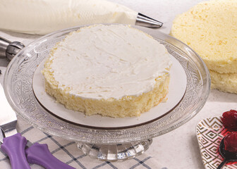 Ingredients making cake. Fresh Homemade sliced sponge cake vanilla biscuit layers, butter cream, cherry. Cherry cake assembly process. dessert recipe background. Whisk whipped cream frozen berries