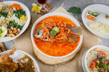 Traditional Indonesian fried fish dish served with spicy pecak sauce made from chili, shallots, and herbs. A bold, flavorful meal perfect for authentic food visuals.