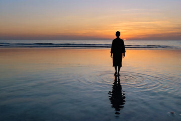 A silhouette of a figure walking toward the horizon over a calm shallow sea at twilight, perfect mirror reflection on the water, pastel colors in sky, spiritual minimalism 