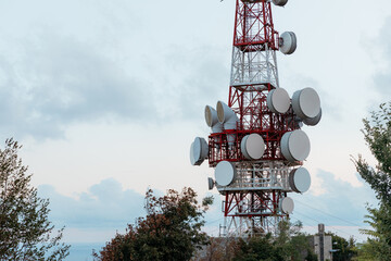 Telecommunication tower dominating the skyline of genoa, italy, during sunset