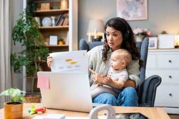 Single mother with baby on lap speaks emotionally via laptop video call to ex-husband about overdue...