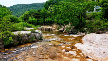 Aerial Drone Footage of a Clear Mountain Stream Flowing Through Mungyeong Countryside in Late Spring and Early Summer, Korea